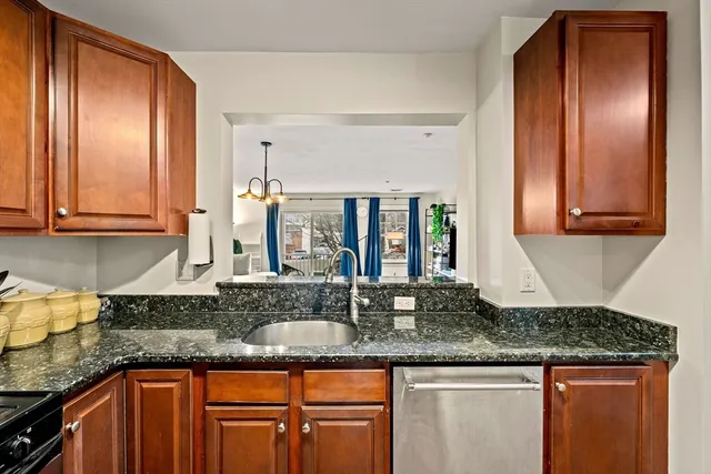 a kitchen with granite countertop stainless steel appliances granite countertop a sink and cabinets