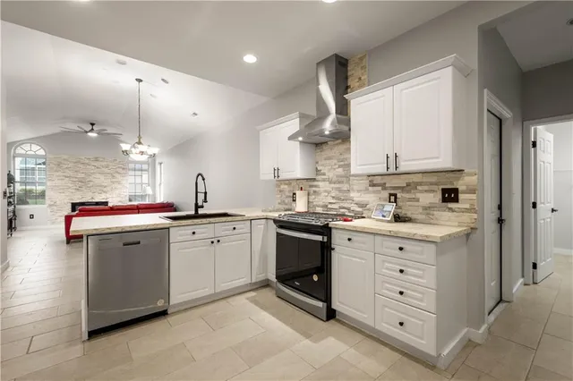 a kitchen with granite countertop white cabinets and white appliances
