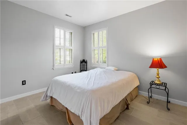 a spacious bedroom with a bed and window