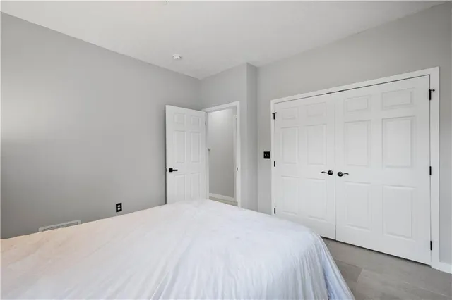 a bedroom with a bed and a cabinet