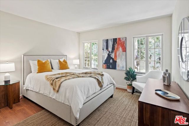 a bedroom with a large bed and a window