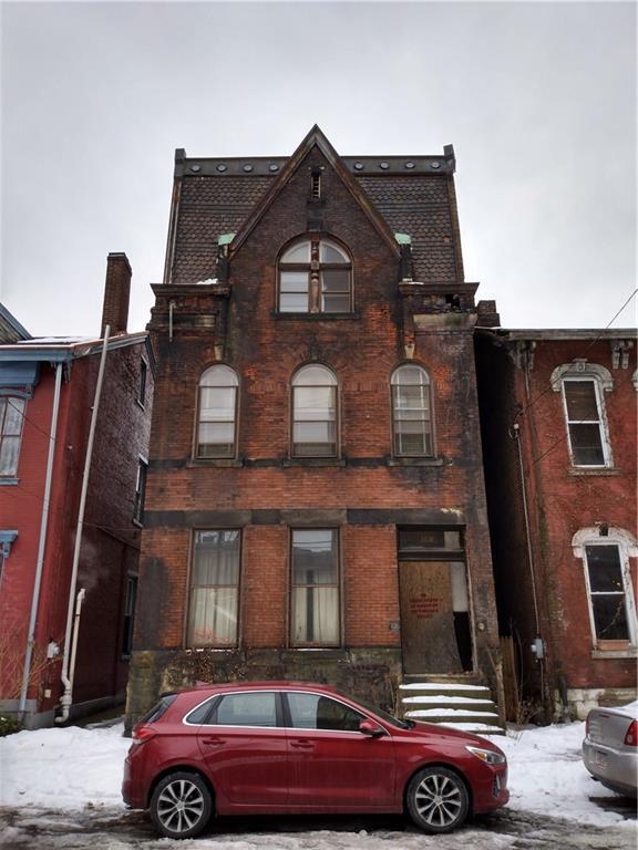 a front view of a house with parking space