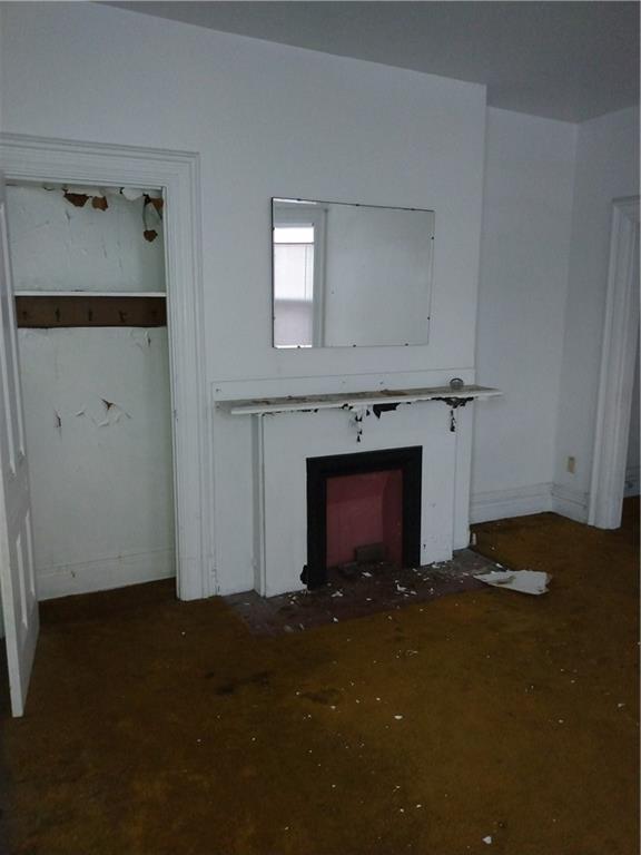 1005 Sheffield Street Pittsburgh, PA 15233 - Photo 12 of 25 a view of a livingroom with wooden floor and a fireplace