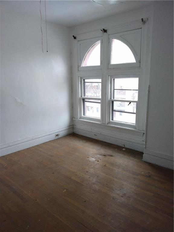1005 Sheffield Street Pittsburgh, PA 15233 - Photo 23 of 25 an empty room with wooden floor and windows