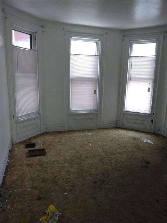 1005 Sheffield Street Pittsburgh, PA 15233 - Photo 4 of 25 an empty room with windows