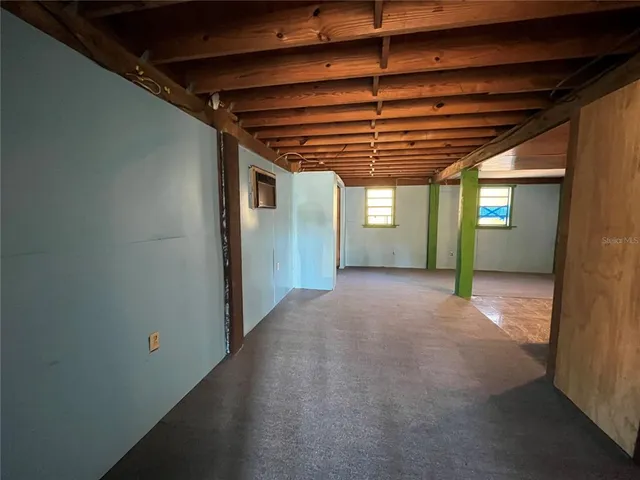 a big room with wooden floor and furniture