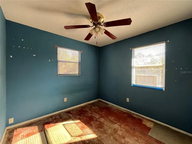 a view of a livingroom with furniture and a window