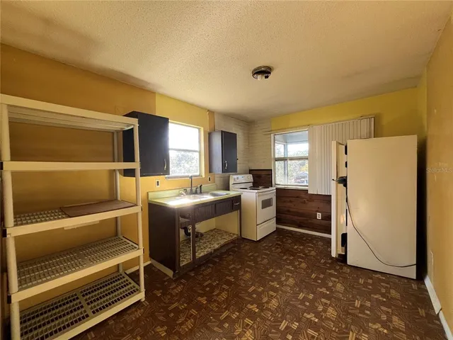 a bathroom with a granite countertop sink and a tub