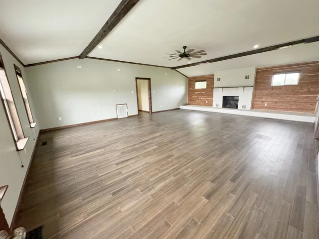 wooden floor in an empty room with a window