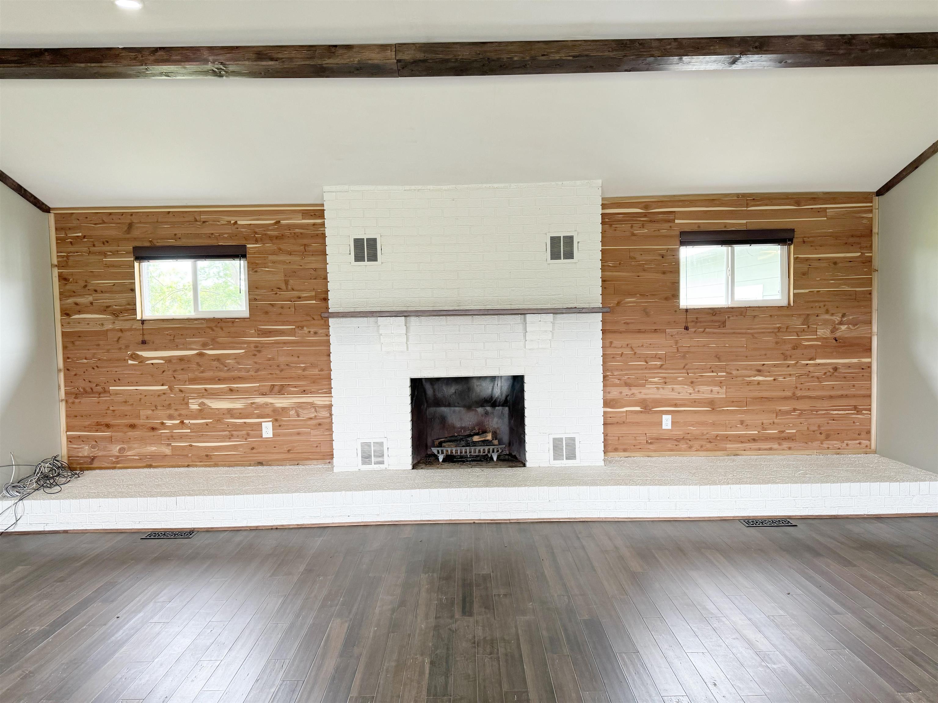 951 Sloan Road Burlison, TN 38015 - Photo 7 of 29 a view of a livingroom with wooden floor and a fireplace