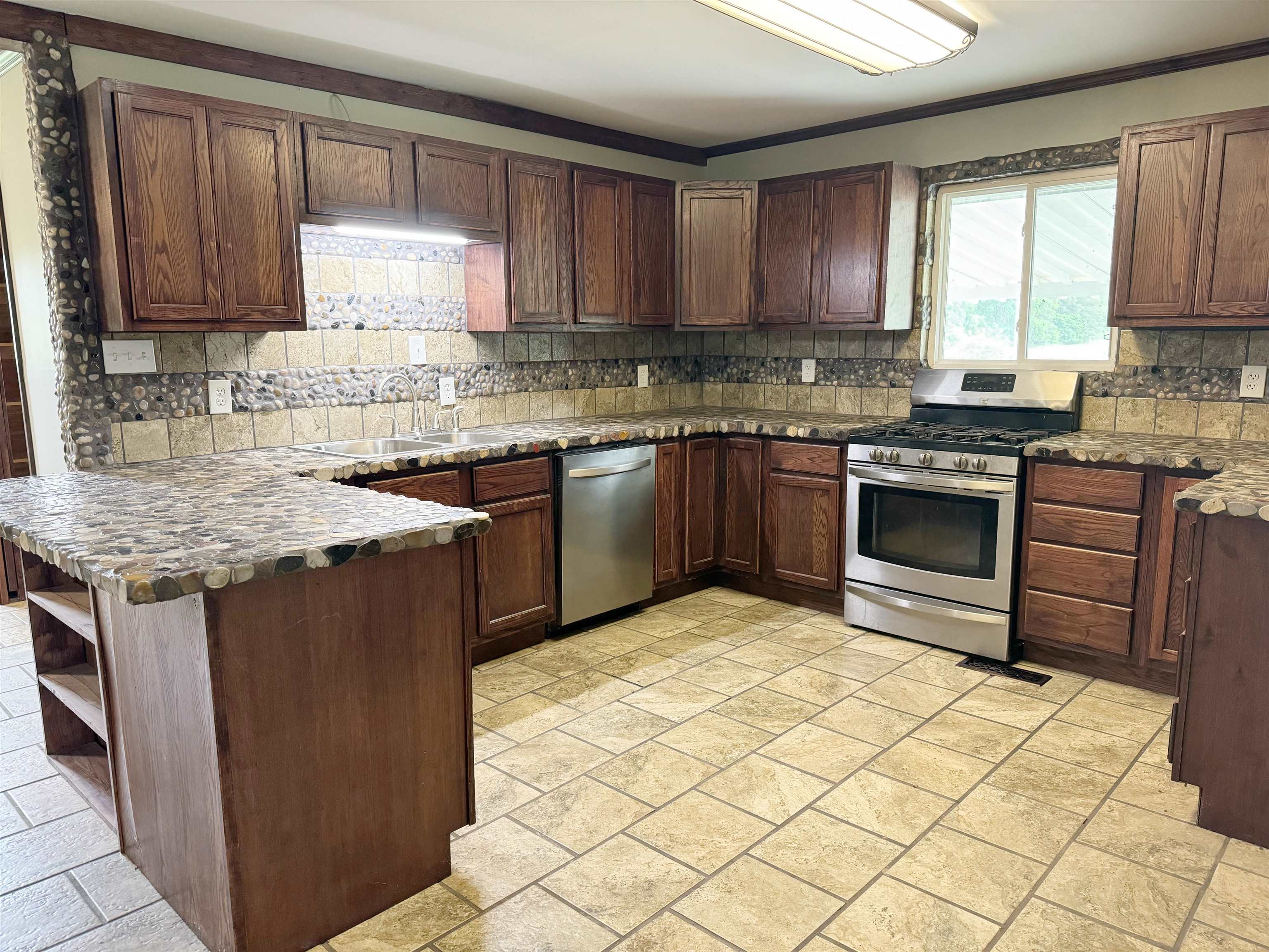 951 Sloan Road Burlison, TN 38015 - Photo 8 of 29 a kitchen with stainless steel appliances granite countertop a stove sink and cabinets