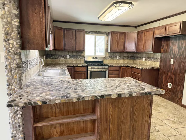 a hallway with a large window and wooden floor