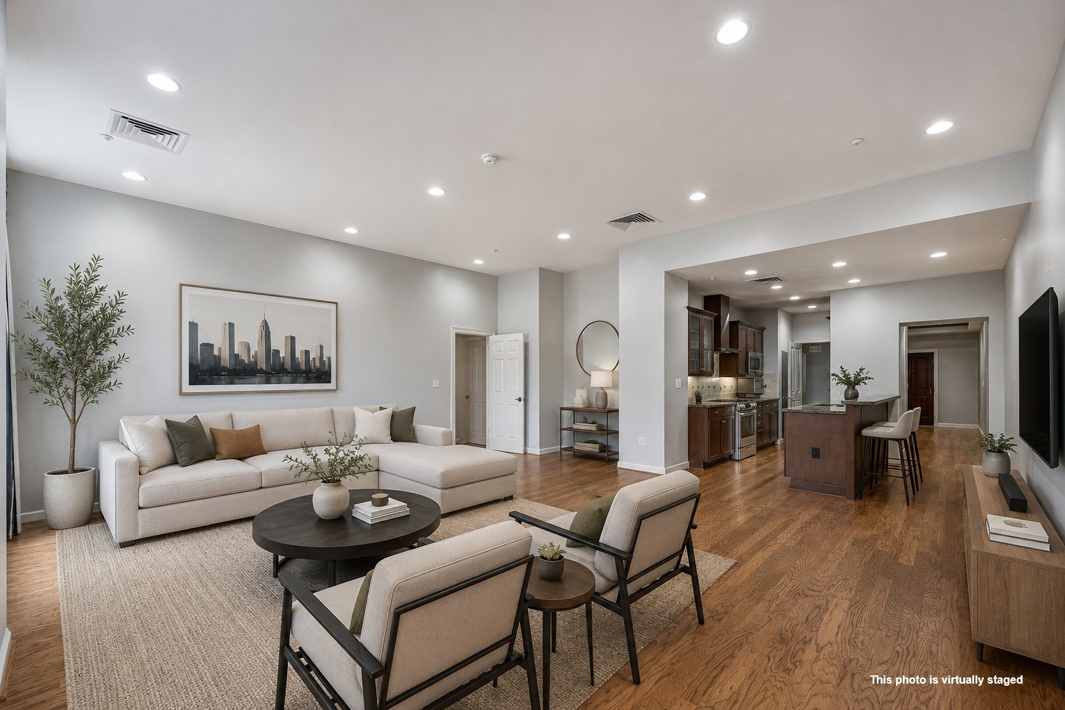 914 Main Street, Unit 910 Houston, TX 77002 - Photo 1 of 32 Virtually staged living room showcasing the open-concept layout with the kitchen in the background, creating a bright and inviting space for everyday living and entertaining.
