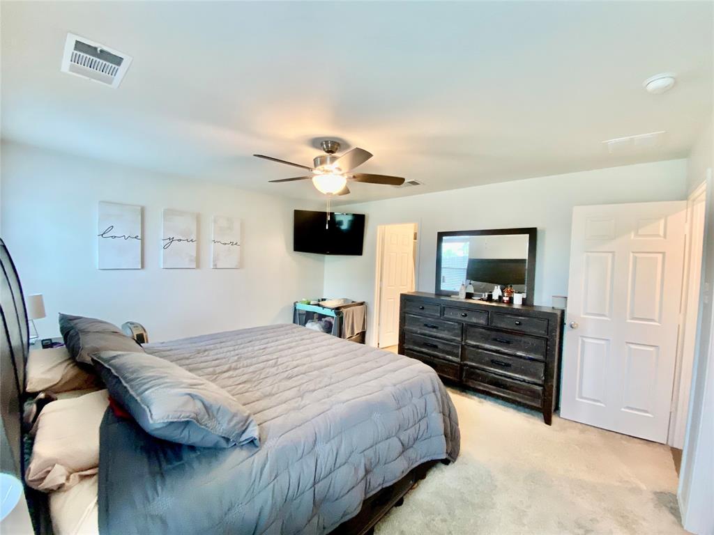 110 West Point Way Elgin, TX 78621 - Photo 9 of 19 Primary bedroom with carpet and ceiling fan