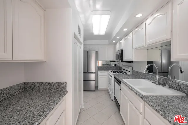 a hallway with wooden floor table and chairs