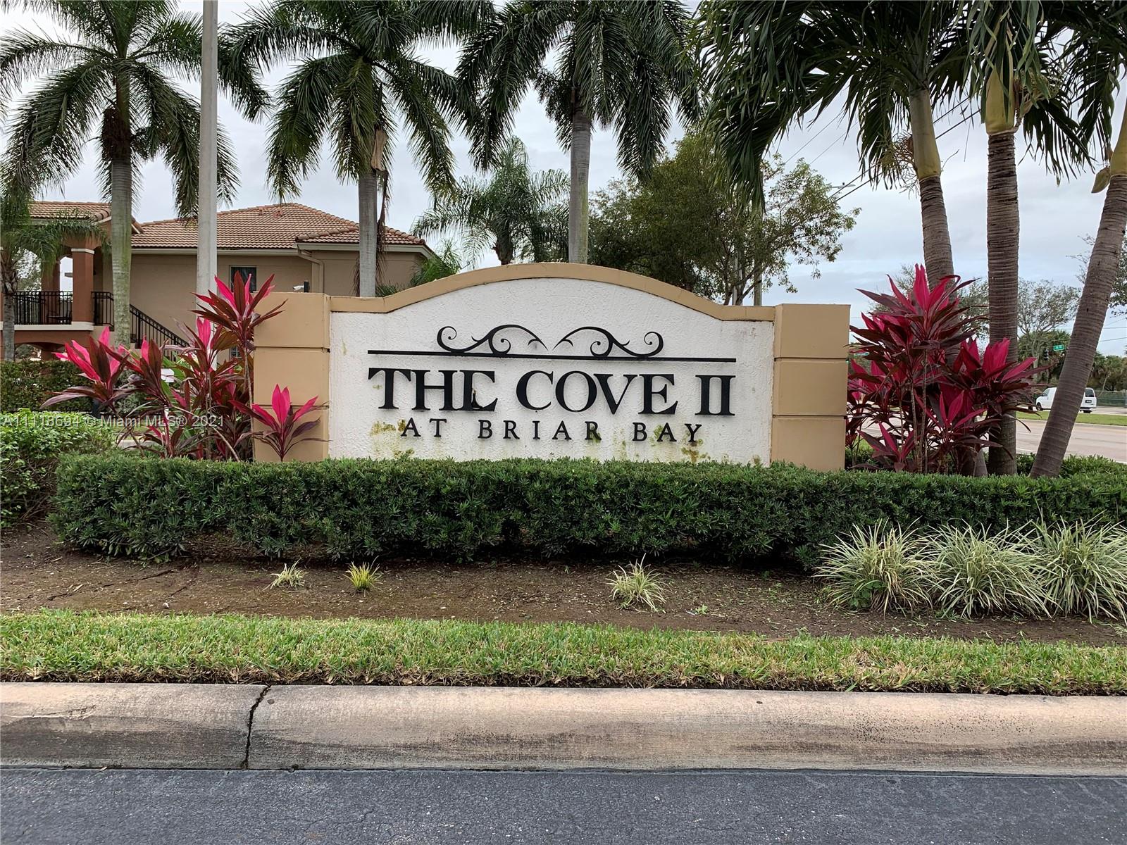 3770 North Jog Road, Unit 103 West Palm Beach, FL 33411 - Photo 1 of 15 a front view of a house with a garden and a garden
