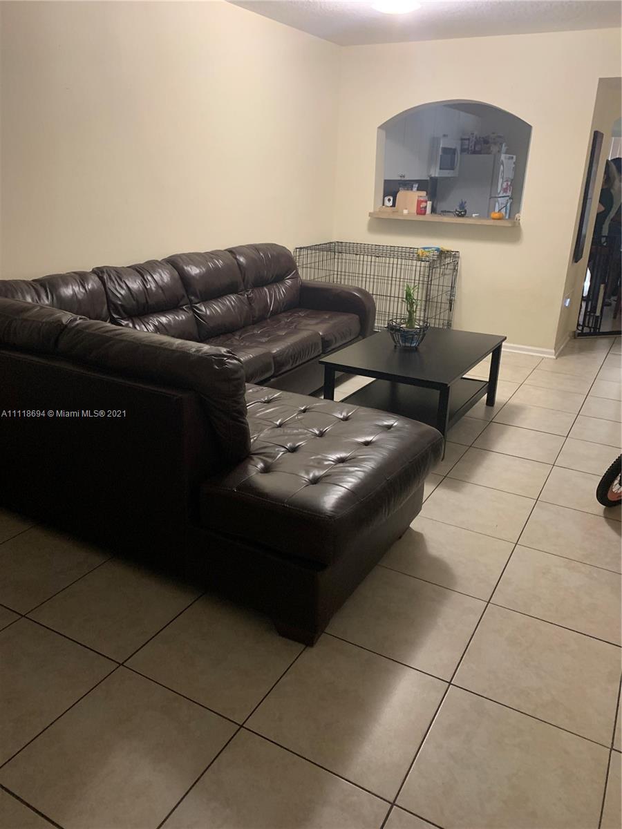 3770 North Jog Road, Unit 103 West Palm Beach, FL 33411 - Photo 2 of 15 a living room with furniture and a wooden floor