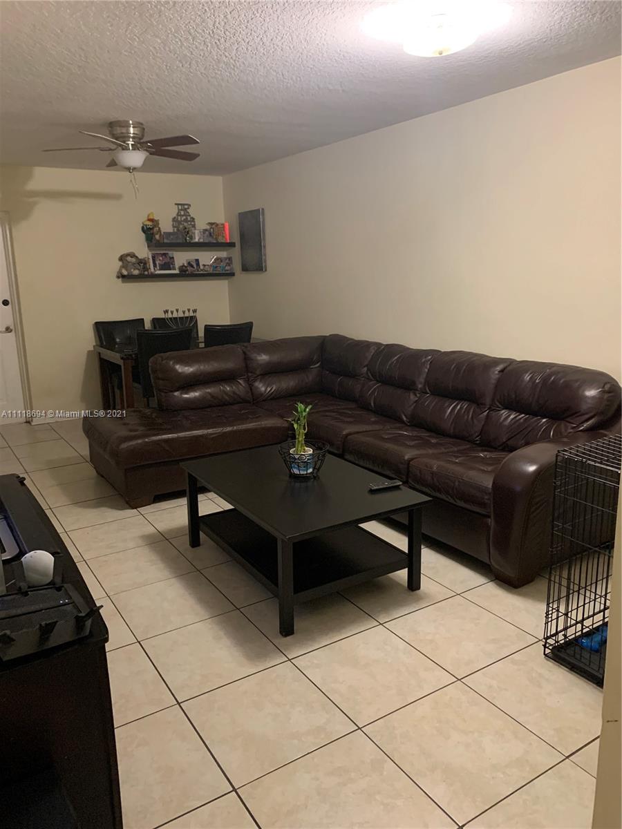 3770 North Jog Road, Unit 103 West Palm Beach, FL 33411 - Photo 3 of 15 a living room with furniture and a rug
