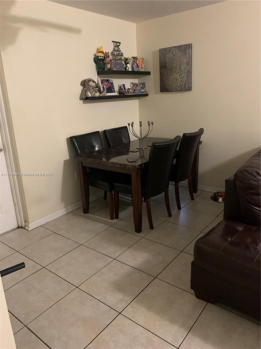 3770 North Jog Road, Unit 103 West Palm Beach, FL 33411 - Photo 4 of 15 a living room with furniture and a table