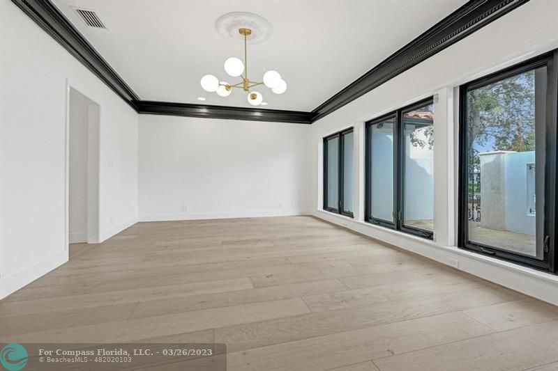 19 Seneca Road Sea Ranch Lakes, FL 33308 - Photo 11 of 48 a view of an empty room with a chandelier