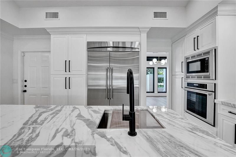 19 Seneca Road Sea Ranch Lakes, FL 33308 - Photo 13 of 48 a bedroom with a bed and a flat screen tv