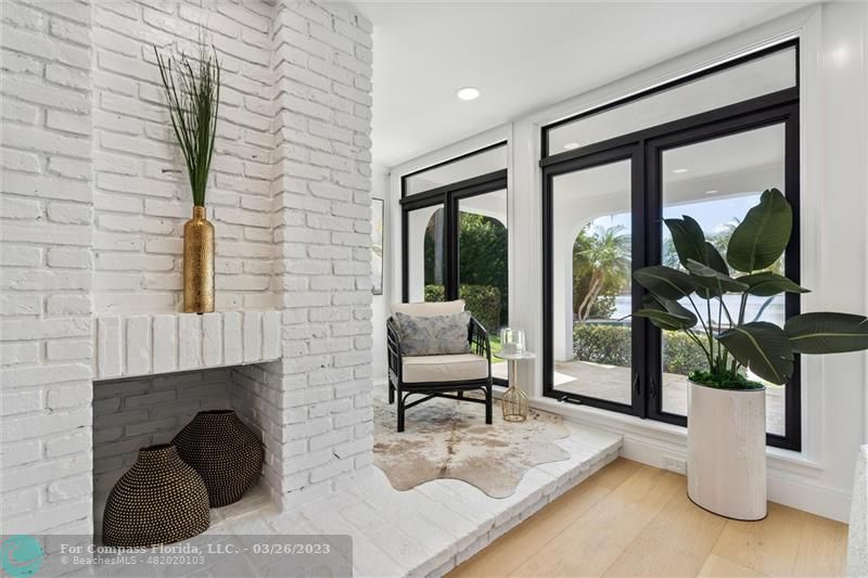 19 Seneca Road Sea Ranch Lakes, FL 33308 - Photo 20 of 48 a living room with furniture and a floor to ceiling window