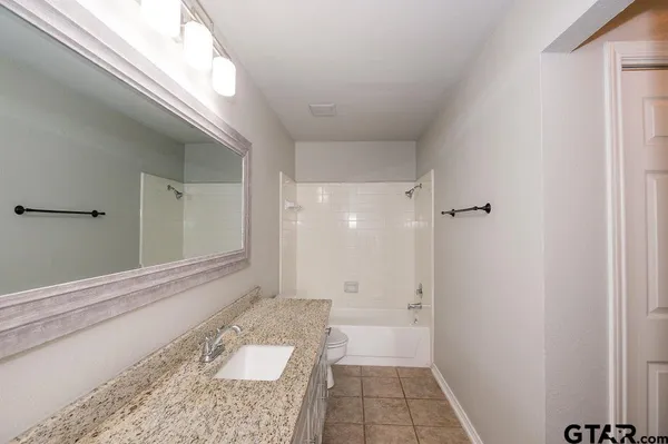 a bathroom with a sink a toilet and a window