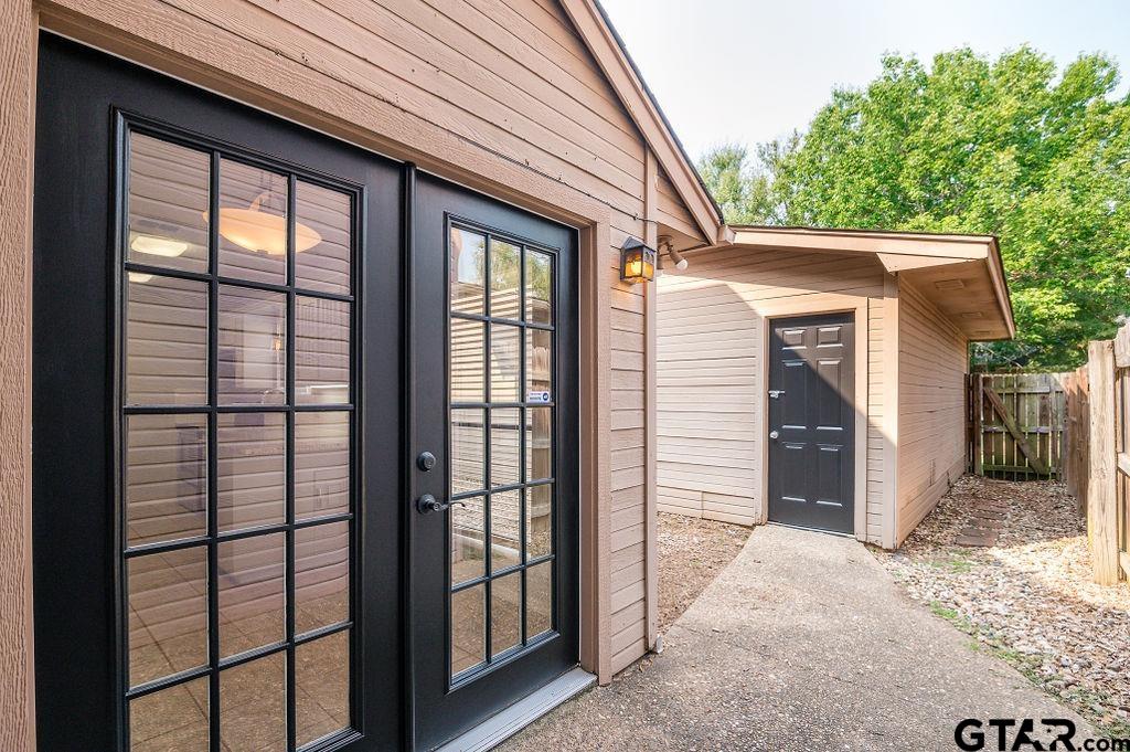 5809 Hollytree Drive Tyler, TX 75703 - Photo 23 of 32 a view of a porch with a door and wooden floor