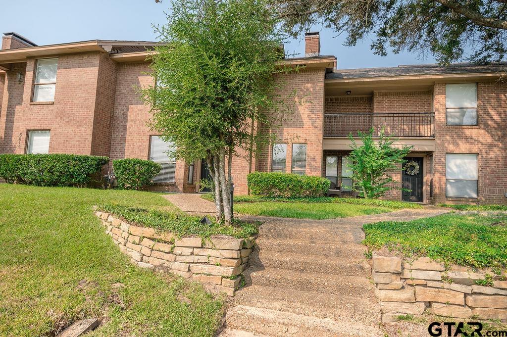 5809 Hollytree Drive Tyler, TX 75703 - Photo 28 of 32 a front view of a house with garden