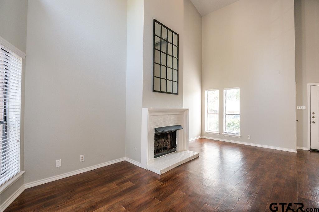 5809 Hollytree Drive Tyler, TX 75703 - Photo 5 of 32 an empty room with windows and fireplace