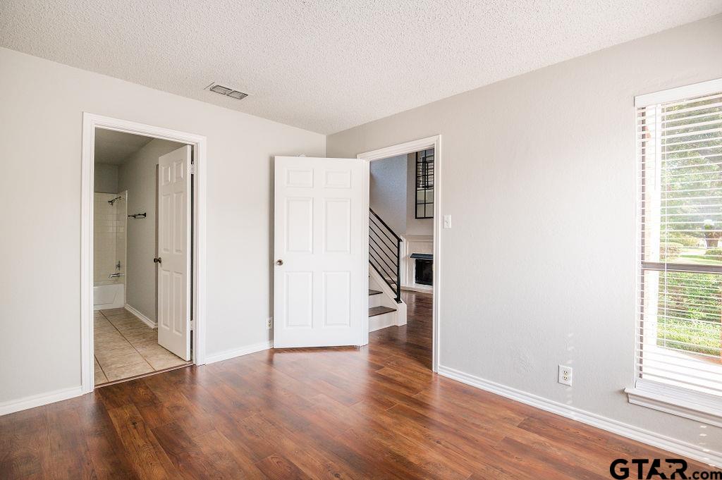 5809 Hollytree Drive Tyler, TX 75703 - Photo 10 of 32 an empty room with wooden floor and windows