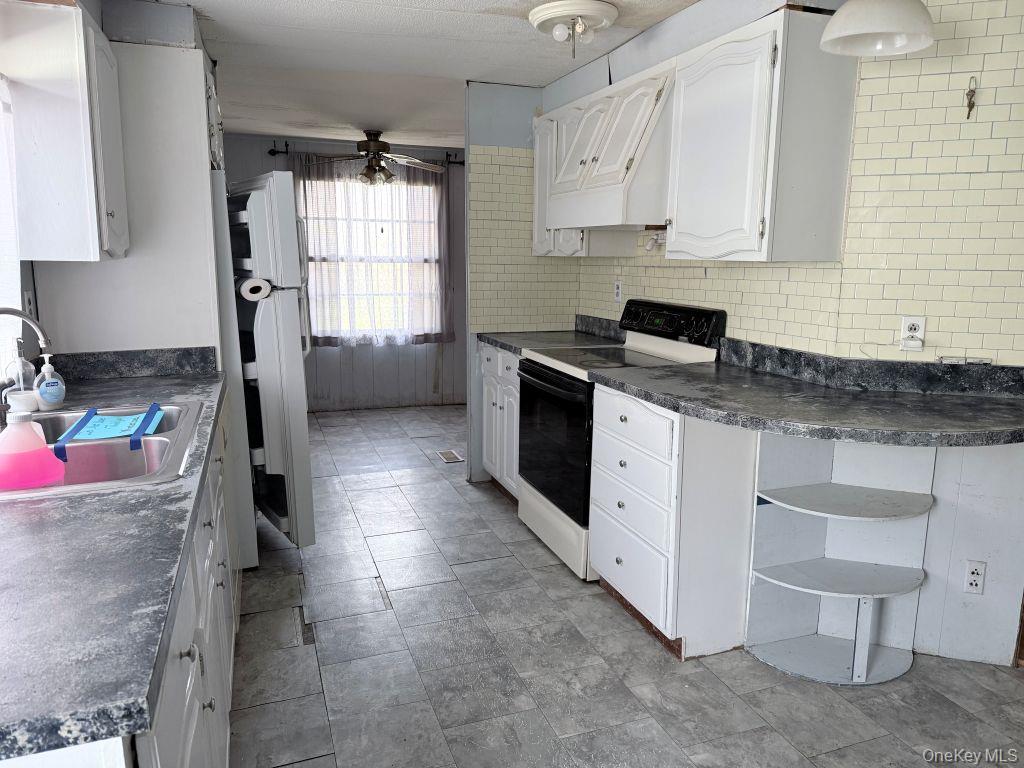 23 Clearview Road Wingdale, NY 12594 - Photo 13 of 21 a kitchen with granite countertop a sink stove and cabinets