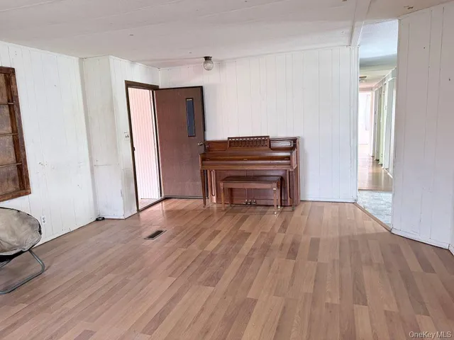 a view of room with window and wooden floor