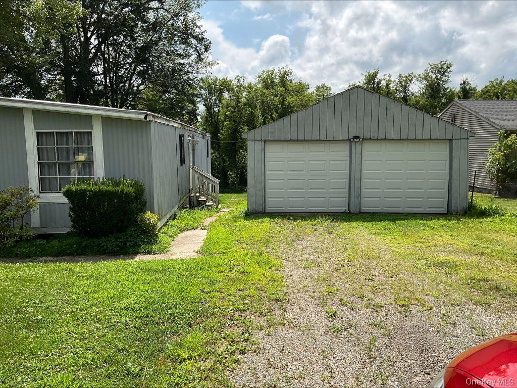 23 Clearview Road Wingdale, NY 12594 - Photo 2 of 21 a view of a house with a yard and garage