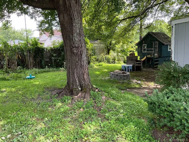 a view of a backyard with a tree