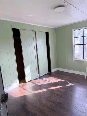 a view of a room with wooden floor and windows
