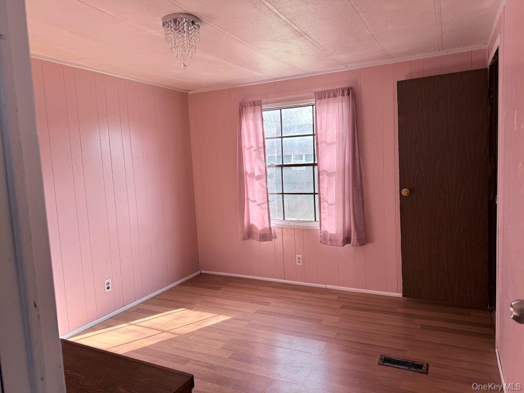 23 Clearview Road Wingdale, NY 12594 - Photo 9 of 21 an empty room with wooden floor and windows