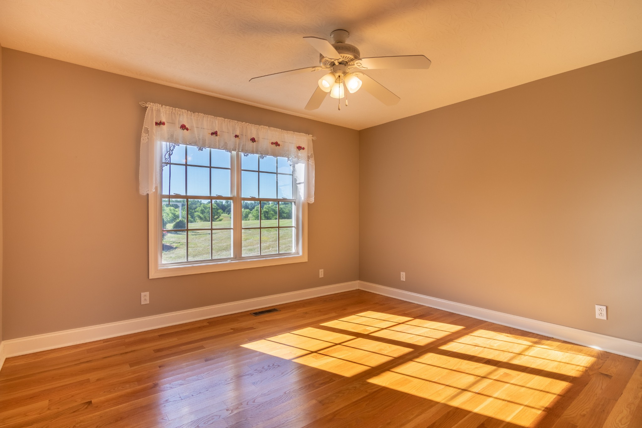 1009 Hummingbird Court Springfield, TN 37172 - Photo 15 of 18 a view of an empty room with window and wooden floor