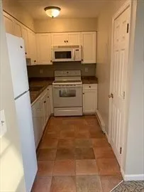 a kitchen with stainless steel appliances a refrigerator sink and microwave