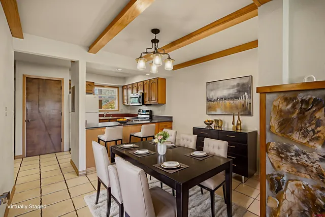 a view of a dining room with furniture and a chandelier
