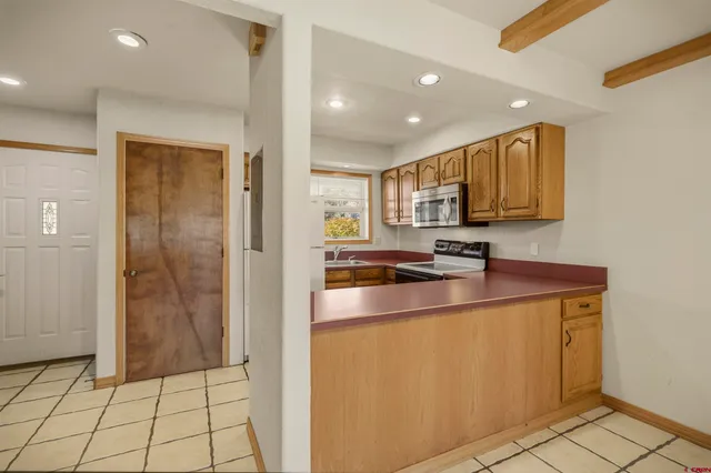 a kitchen with stainless steel appliances a sink stove and refrigerator