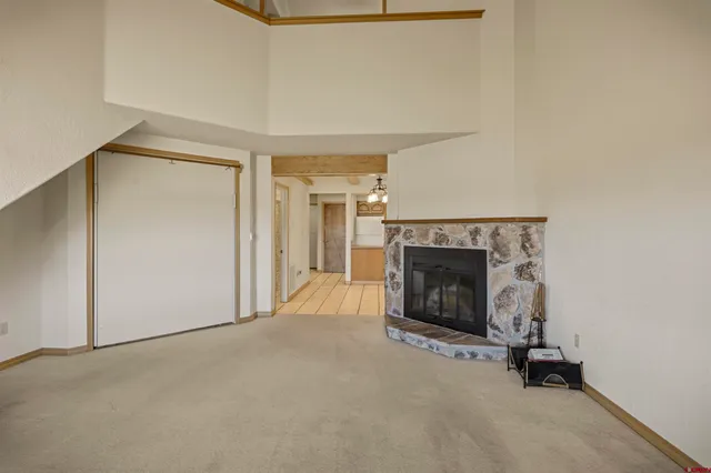 a view of a livingroom with a fireplace and a window
