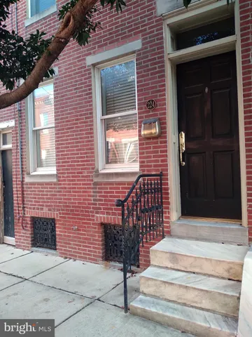 a front view of a house with a window and brick walls