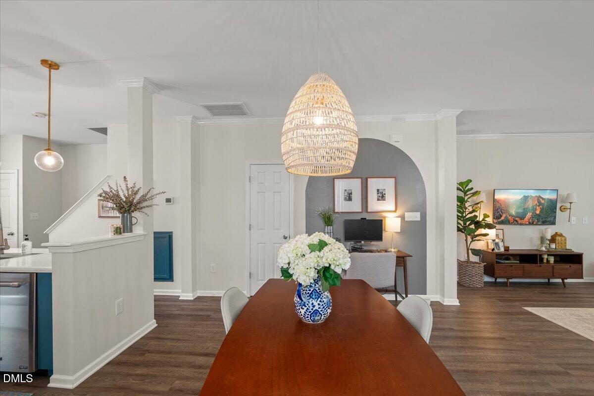 8449 Central Drive Raleigh, NC 27613 - Photo 6 of 38 a living room with furniture flowerpot and wooden floor