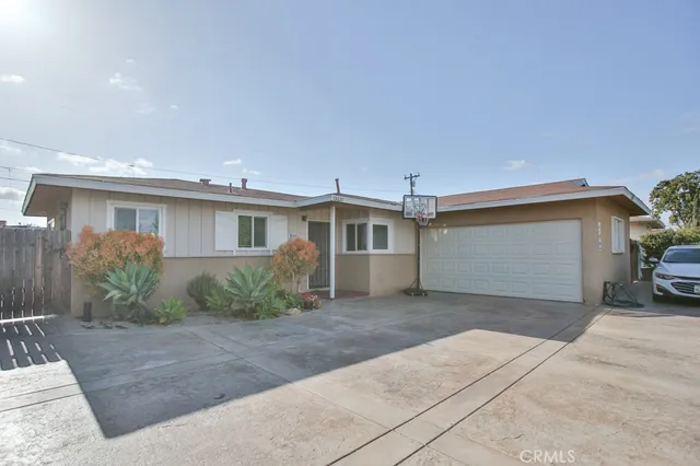 a front view of a house with a garden and plants