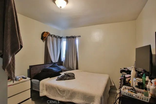 a bedroom with a bed and a flat tv screen