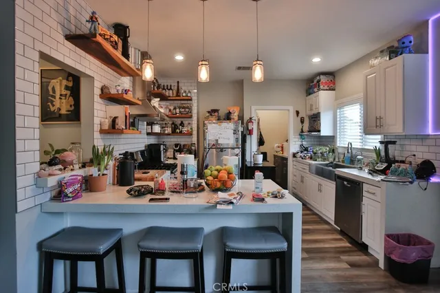 a kitchen view of a dining table chairs and chandelier