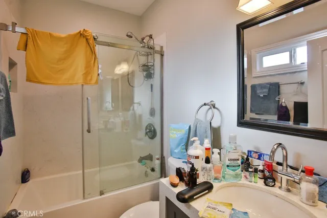 a bathroom with a sink tub and shower