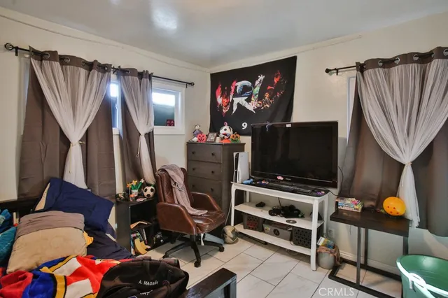 a bedroom with furniture and a window