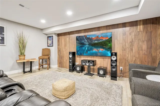 a bedroom with a bed a flat screen tv and a window